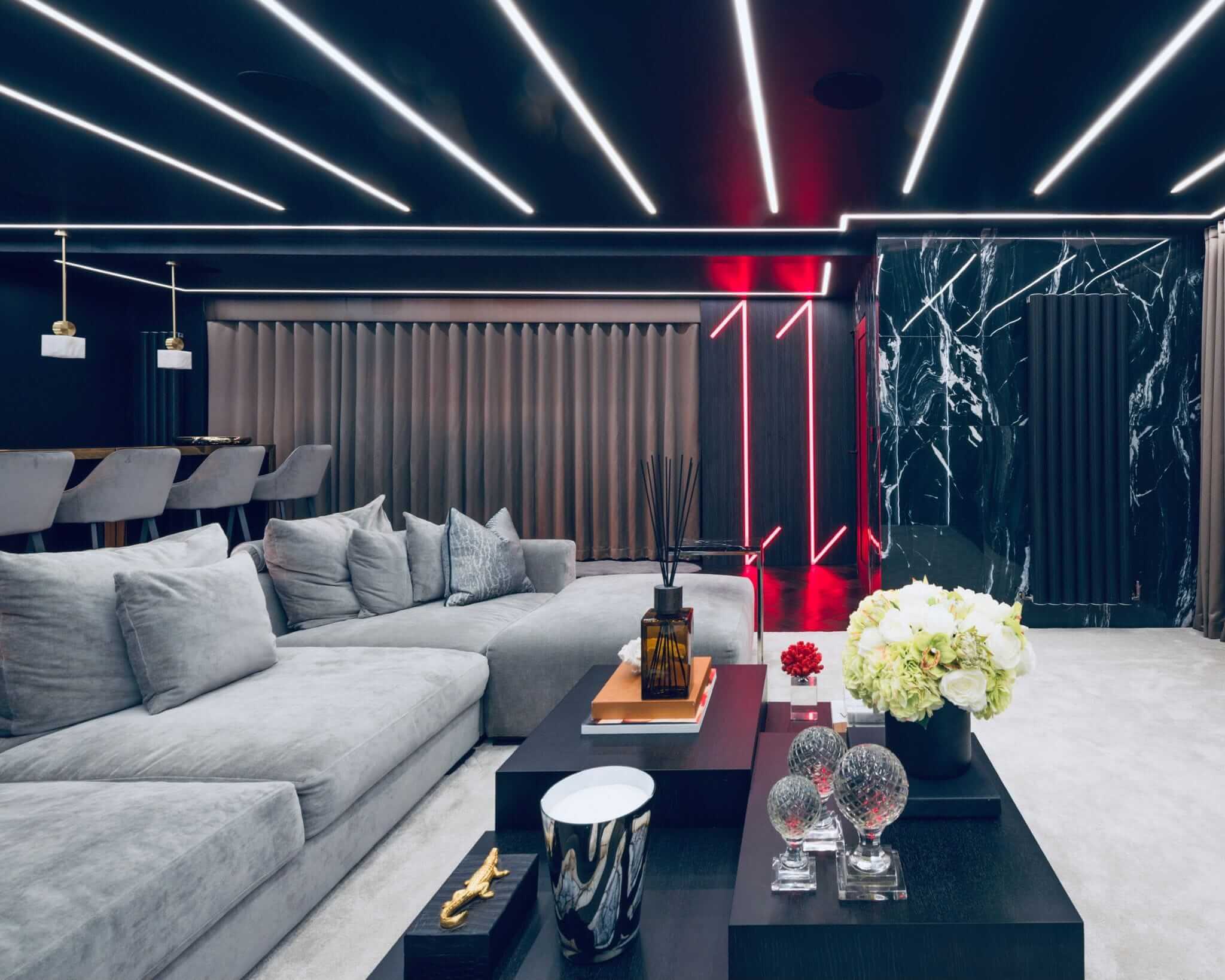 Living room with recessed linear LED ceiling lighting installed by AMP Electrical